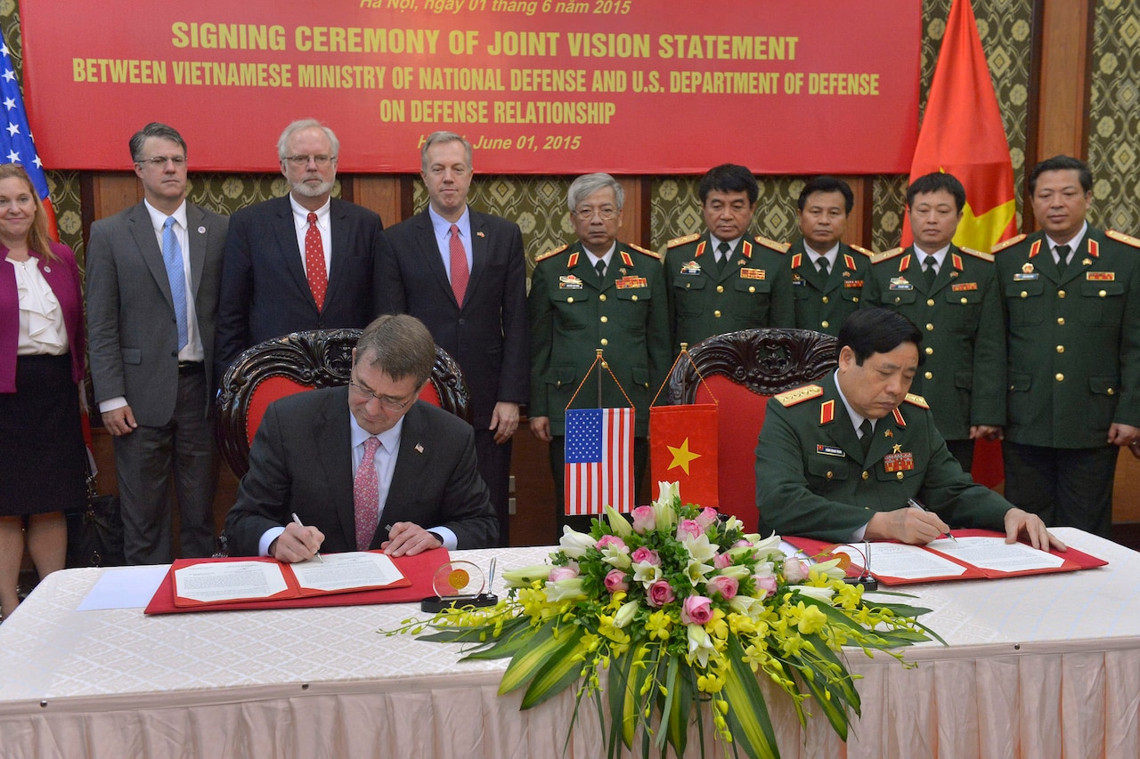 Defense Secretary Ash Carter, left, and Vietnamese Defense Minister Gen. Phung Quang Thanh sign a joint vision statement after meeting at the Vietnamese Ministry of Defense in Hanoi, Vietnam, June 1, 2015. Carter is on a 10-day trip to meet with officials of Asia-Pacific partner nations and affirm the U.S. commitment to the region. DoD photo by Glenn Fawcett