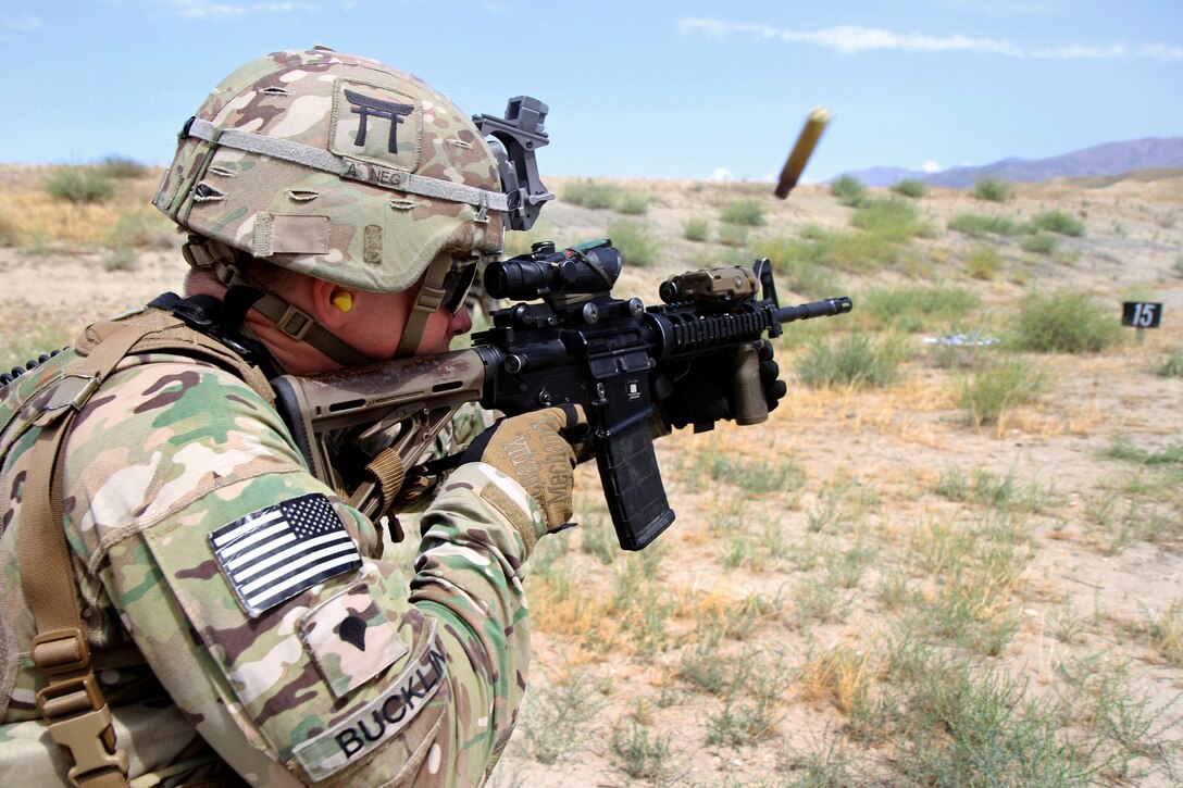 U.S. Army Spc. Ian Bucklin fires his M4 carbine during partnered marksmanship live-fire training on Tactical Base Gamberi in eastern Afghanistan, May 29, 2015. Bucklin is an infantryman assigned to the 101st Airborne Division.