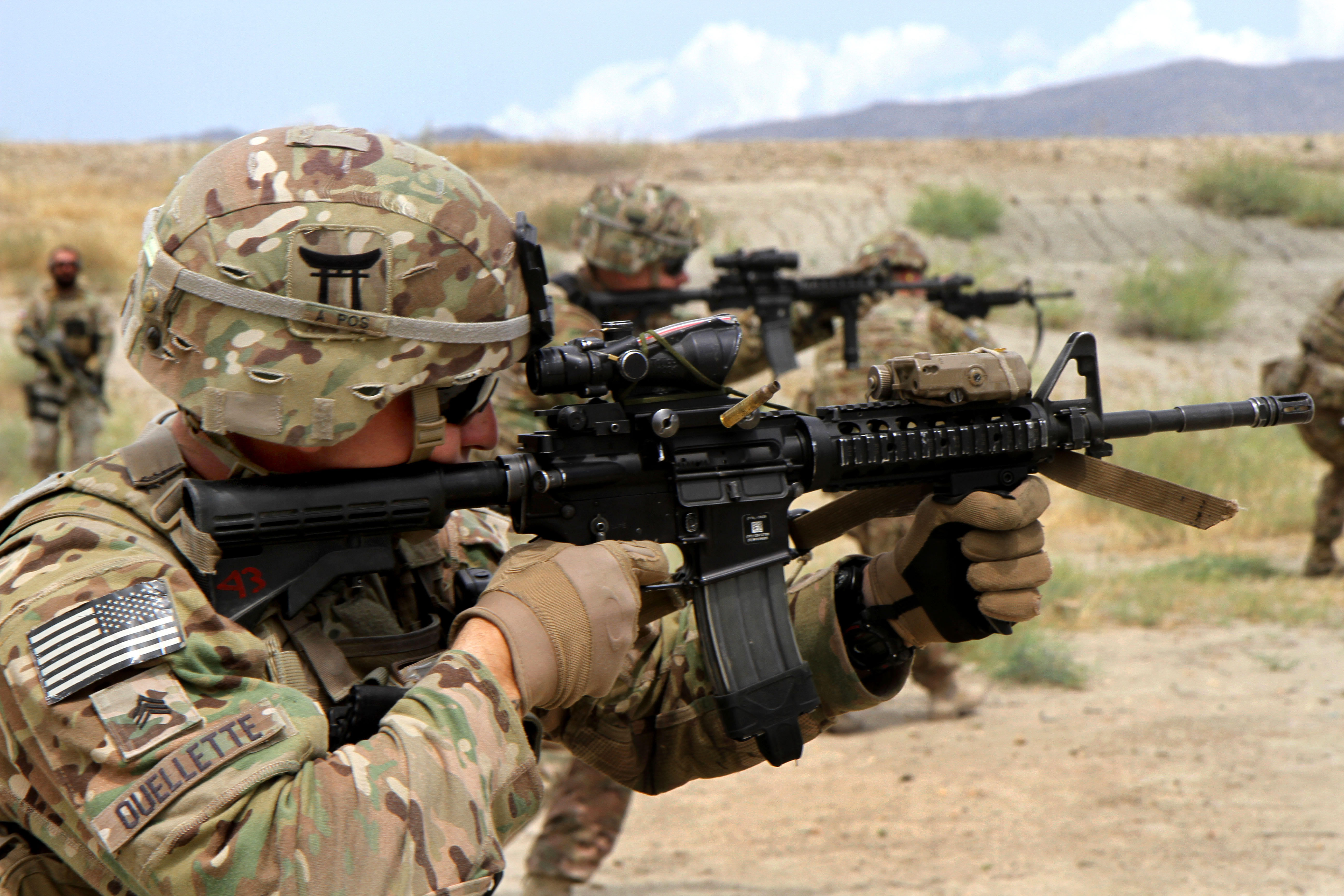 U.S. Army Sgt. Douglas Ouellette fires his M4 carbine during partnered ...