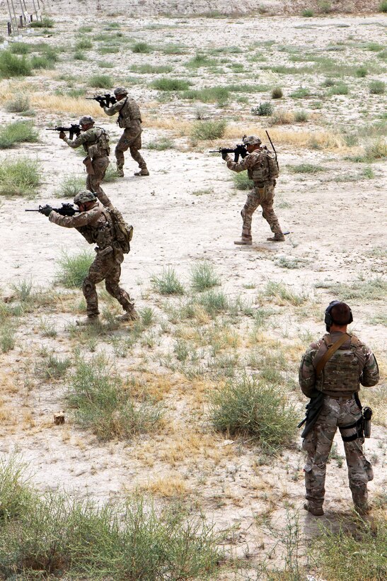 A range safety officer, lower right, observes, as U.S. soldiers participate in partnered marksmanship live-fire training on Tactical Base Gamberi in eastern Afghanistan, May 29, 2015.