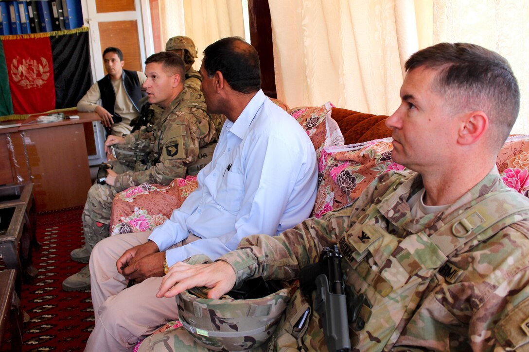 U.S. Army Col. Douglas C. Crissman, foreground, and U.S. Army Lt. Col. Zachary L. Miller, center, attend a meeting with Afghan officials before participating in a ribbon-cutting ceremony for the only orphanage in Parwan, Afghanistan, May 14, 2015. 
Crissman is deputy Commanding General –Support, U.S. Forces - Afghanistan, and Miller is commander, Task Force Solid, assigned to the 101st Airborne Division. 
