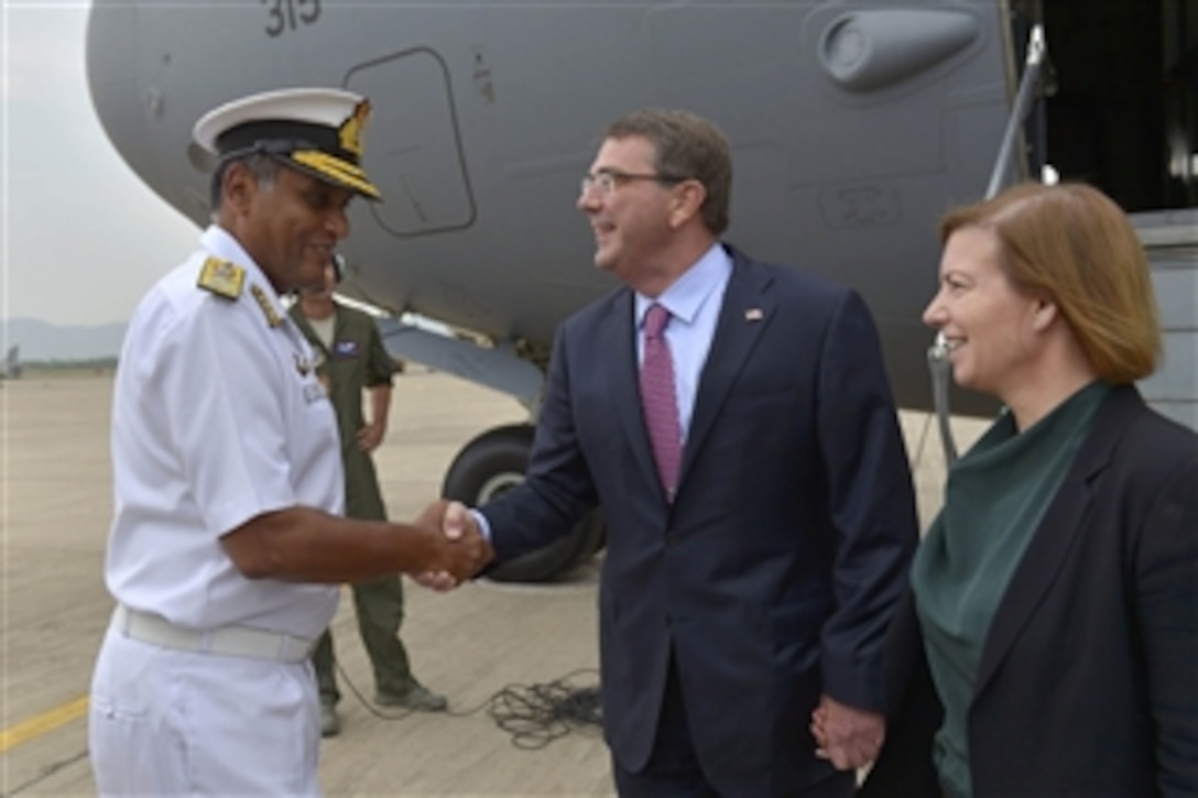 U.S. Defense Secretary Ash Carter and his wife, Stephanie, talk with Indian Navy Vice Adm. Bimal Verma, who welcomes them as they arrive in Vizag, India, June 2, 2015, to visit the country's Eastern Naval Command and tour the frigate INS Sahyadri. 