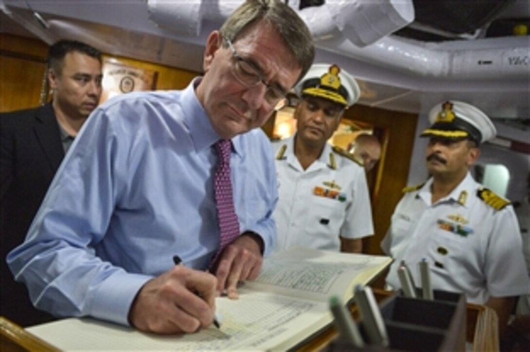 U.S. Defense Secretary Ash Carter signs the guest book for the Indian Navy frigate INS Sahyadri during a tour of the warship in Vizag, India, June 2, 2015. Carter is on a 10-day trip to the Asia-Pacific to meet with partner nations and affirm U.S. commitment to the region.