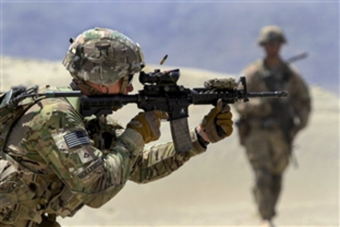 U.S. Army Pfc. Charles Hollembeak fires an M4 carbine during partnered marksmanship live-fire training on Tactical Base Gamberi in eastern Afghanistan, May 29, 2015. Hollembeak is an infantryman assigned to the 101st Airborne Division.