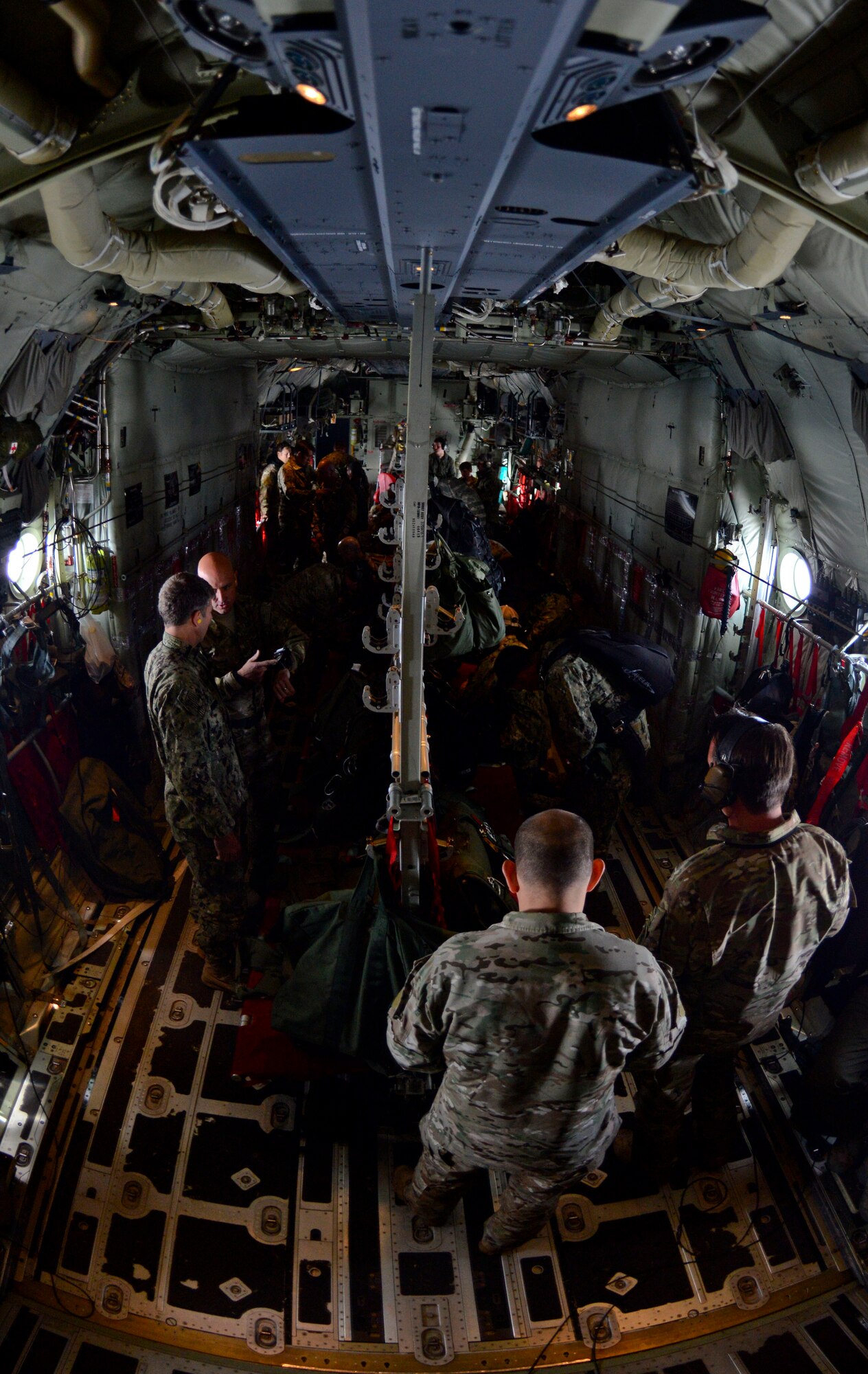 Operators from U.S. Special Operations Command -- Europe prepare prior their gear before a high-altitude, low-opening jump May 30, 2015, over Mont Saint-Michele, France. The paratroopers jumped from an MC-130J Commando II assigned to the 67th Special Operations Squadron from as high as 13,000 feet to commemorate the 71st anniversary of the liberation of France during World War II. (U.S. Air Force photo by Staff Sgt. Micaiah Anthony)