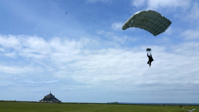A Special Operations Command Europe operator prepares to land just outside of the Mont Saint Michel Abbey in Normandy, France, on May 30, 2015, to commemorate the 71st anniversary of the liberation of France as well as those who served in World War II. Airmen assigned to the 321st Special Tactics Squadron, along with other operators within SOCEUR, performed military free fall jumps outside of the U.N. designated world heritage site. (U.S. Air Force photo/Maj. Christina Hoggatt) 