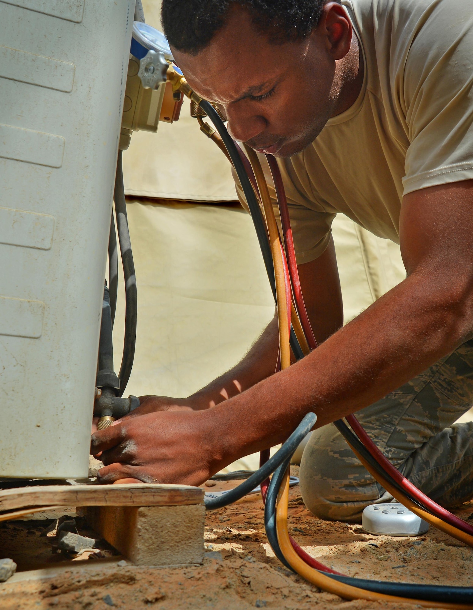 Senior Airman Dorian, heating, ventilation and air conditioning journeyman, prepares an AC unit for relocation at an undisclosed location in Southwest Asia May 7, 2015. HVAC Airmen are responsible for installing, operating, maintaining, and repairing heating, ventilation, air conditioning and refrigeration systems, combustion equipment, and industrial air compressors. (U.S. Air Force photo/Tech. Sgt. Jeff Andrejcik)