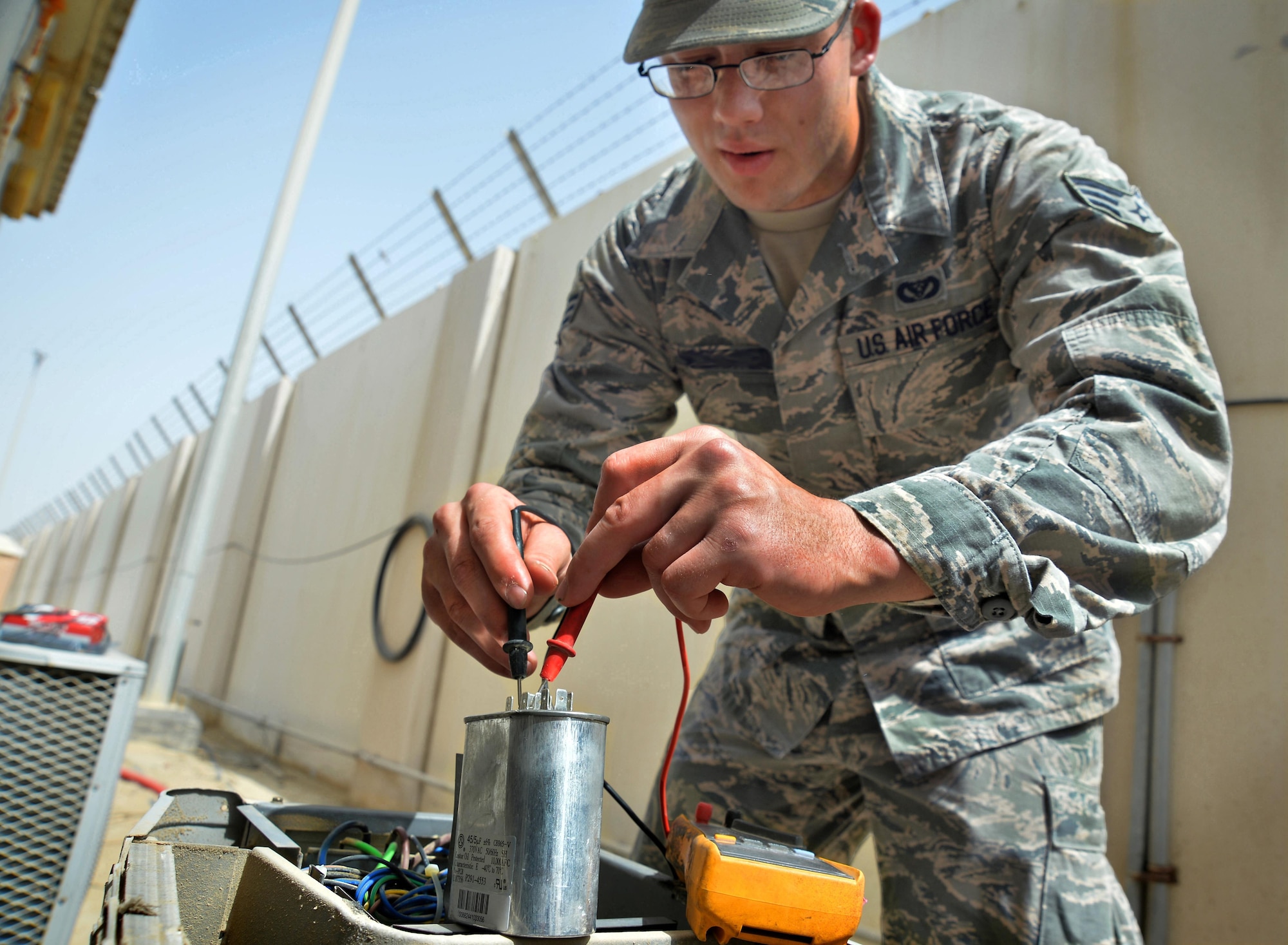 Senior Airman Trent, heating, ventilation and air conditioning journeyman, conducts a diagnostic test on a split AC unit at an undisclosed location in Southwest Asia May 7, 2015. HVAC Airmen are responsible for installing, operating, maintaining, and repairing heating, ventilation, air conditioning and refrigeration systems, combustion equipment, and industrial air compressors. (U.S. Air Force photo/Tech. Sgt. Jeff Andrejcik)