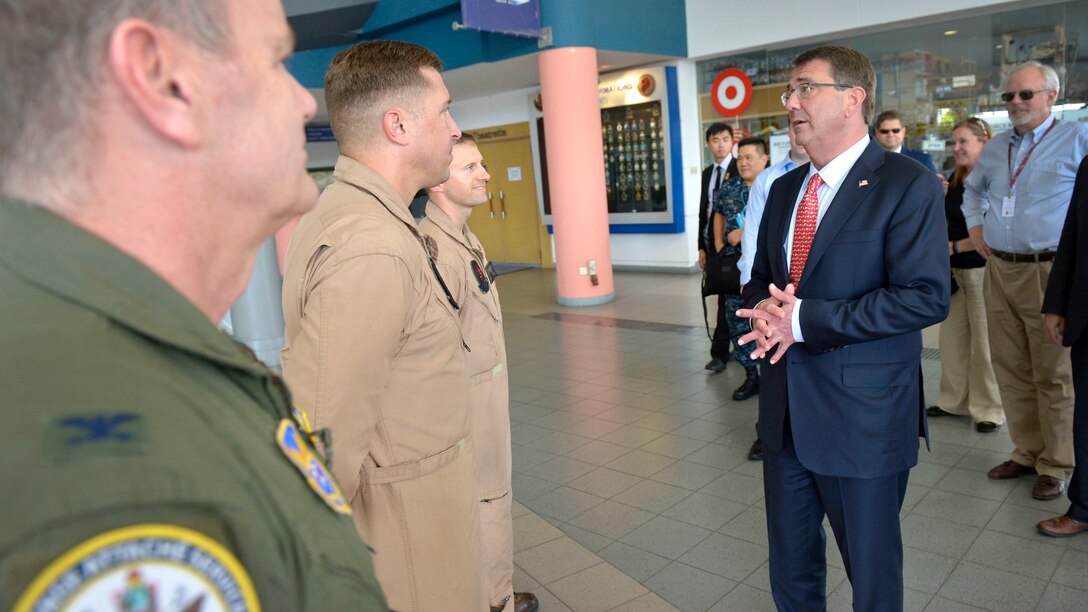 Secretary of Defense Ash Carter meets the flight crew of the MV-22 Osprey that will take him to survey the Straits of Malacca off the coast of Singapore, May 29, 2015.