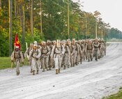 Marines with Electronics Maintenance Company, 2nd Maintenance Battalion, hike to the Battle Skills Training School to conduct the endurance course, aboard Camp Lejeune, N.C., May 29, 2015. ELMACO hiked approximately two miles to the school and then conducted the course to build camaraderie and say farewell to their commanding officer, Maj. Brian L. White. (U. S. Marine Corps photo by Cpl. Shawn Valosin)