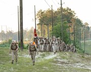 Marines with Electronics Maintenance Company, 2nd Maintenance Battalion, hike to the Battle Skills Training School to conduct the endurance course, aboard Camp Lejeune, N.C., May 29, 2015. ELMACO hiked approximately two miles to the school and then conducted the course to build camaraderie and say farewell to their commanding officer, Maj. Brian L. White. (U. S. Marine Corps photo by Cpl. Shawn Valosin)
