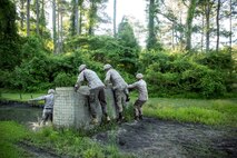 Marines with Electronics Maintenance Company, 2nd Maintenance Battalion, race over a barrier during the endurance course at the Battle Skills Training School aboard Camp Lejeune, N.C., May 29, 2015. ELMACO hiked approximately two miles to the school and then conducted the course to build camaraderie and say farewell to their commanding officer, Maj. Brian L. White. (U. S. Marine Corps photo by Cpl. Shawn Valosin)