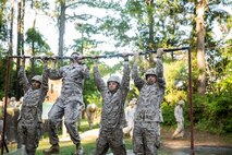 Marines with Electronics Maintenance Company, 2nd Maintenance Battalion, conduct pull-ups during the endurance course at the Battle Skills Training School aboard Camp Lejeune, N.C., May 29, 2015. ELMACO hiked approximately two miles to the school and then conducted the course to build camaraderie and say farewell to their commanding officer, Maj. Brian L. White. (U. S. Marine Corps photo by Cpl. Shawn Valosin)