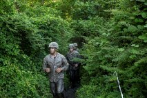 Marines with Electronics Maintenance Company, 2nd Maintenance Battalion, sprint through the forest during the endurance course at the Battle Skills Training School aboard Camp Lejeune, N.C., May 29, 2015. ELMACO hiked approximately two miles to the school and then conducted the course to build camaraderie and say farewell to their commanding officer, Maj. Brian L. White. (U. S. Marine Corps photo by Cpl. Shawn Valosin)