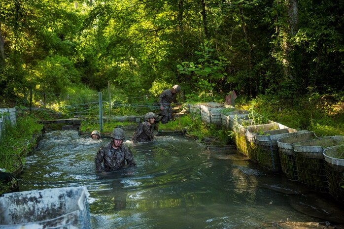 Marines with Electronics Maintenance Company, 2nd Maintenance Battalion, rinse off in a pool after completing the endurance course at the Battle Skills Training School aboard Camp Lejeune, N.C., May 29, 2015. ELMACO hiked approximately two miles to the school and then conducted the course to build camaraderie and say farewell to their commanding officer, Maj. Brian L. White. (U. S. Marine Corps photo by Cpl. Shawn Valosin)