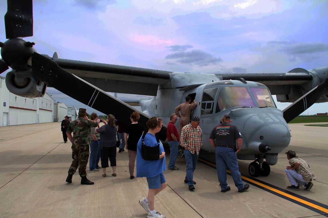 A crowed gathers around an MV22 Osprey tiltrotor aircraft, which made stops at Owatonna, MN while another aircraft landed in Grand Forks, N.D., to showcase Marine Corps aviation technology and equimpment to the public, June 2. The Aircraft were flying from Marine Corps Air Station New River, N.C., to Marine Corps Air Station Yuma, AZ.