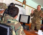 Iowa Army National Guard Lt. Col. Tim Glynn, Panjshir Embedded Training Team
commander, instructs members of the Operations Coordination Center-Provincial
staff on emergency response planning and operations Feb. 7 at the Panjshir
OCC-P headquarters in Afghanistan. The ETT is part of the 2nd Brigade Combat
Team, 34th Infantry Division, Task Force Red Bulls. Glynn used the state of
Iowa's Emergency Decision Matrix to help the OCC-P build a written plan for
Panjshir Province's winter emergency response.