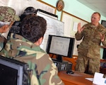 Iowa Army National Guard Lt. Col. Tim Glynn, Panjshir Embedded Training Team
commander, instructs members of the Operations Coordination Center-Provincial
staff on emergency response planning and operations Feb. 7 at the Panjshir
OCC-P headquarters in Afghanistan. The ETT is part of the 2nd Brigade Combat
Team, 34th Infantry Division, Task Force Red Bulls. Glynn used the state of
Iowa's Emergency Decision Matrix to help the OCC-P build a written plan for
Panjshir Province's winter emergency response.