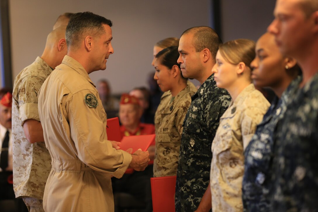 Maj. Gen. Michael Rocco, 3rd Marine Aircraft Wing commanding general, presents awards to Marines and Sailors with 3rd MAW during a Noncommissioned Officer, Marine and Sailors of the Quarter awards ceremony aboard Marine Corps Air Station Miramar, California, June 2. Marines and Sailors from 3rd MAW and MCAS Miramar were recognized for their outstanding performance. Representatives from outlets such as GEICO and Navy Federal Credit Union showed their thanks and support with gifts for those awarded at the ceremony.