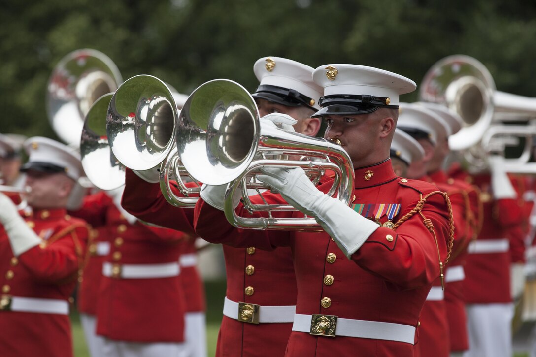 U.S. Marines with the Marine Corps Drum and Bugle Corps perform during the sunset parade at the Marine Corps War Memorial, Arlington, Va., June 2, 2015. Mr. Bob Simmons, majority staff director, House Armed Services Committee, and Paul Arcangeli, minority staff director, House Armed Services Committee, were guests of honor for the parade, and Lt. Gen. Jon M. Davis, deputy commandant, Aviation, was the hosting official. Since September 1956, marching and musical units from Marine Barracks Washington, D.C., have been paying tribute to those who’s “Uncommon valor was a common virtue” by presenting sunset parades in the shadow of the 32-foot high figures of the United States Marine Corps War Memorial. (U.S. Marine Corps photo by Lance Cpl. Samantha K. Draughon/ Released)
