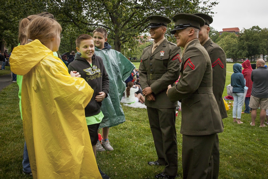 U.S. Marines with Marine Barracks Washington, D.C. speak with guests prior to the start of a sunset parade at the Marine Corps War Memorial, Arlington Va., June 2, 2015. Mr. Bob Simmons, majority staff director, House Armed Services Committee, and Mr. Paul Arcangeli, minority staff director, House Armed Services Committee, were guests of honor for the parade, and Lt. Gen. Jon M. Davis, deputy commandant, Aviation, was the hosting official. Since September 1956, marching and musical units from Marine Barracks Washington, D.C., have been paying tribute to those whose “uncommon valor was a common virtue” by presenting sunset parades in the shadow of the 32-foot high figures of the United States Marine Corps War Memorial. (U.S. Marine Corps photo by Lance Cpl. Christopher J. Nunn/Released)