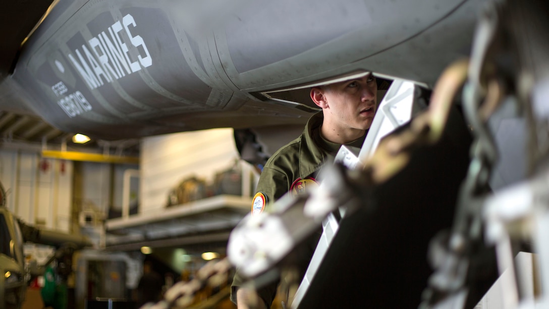 Lance Cpl. Zachary McCarty, an avionics technician from Training and Evaluation Squadron 22, reconnects hardware in an F-35B Lightning II Joint Strike Fighter after maintenance aboard the USS Wasp, May 24, 2015. The Avionics team aboard the Wasp for operational testing assembles, controls and evaluates the electrical and computer systems of the F-35B.