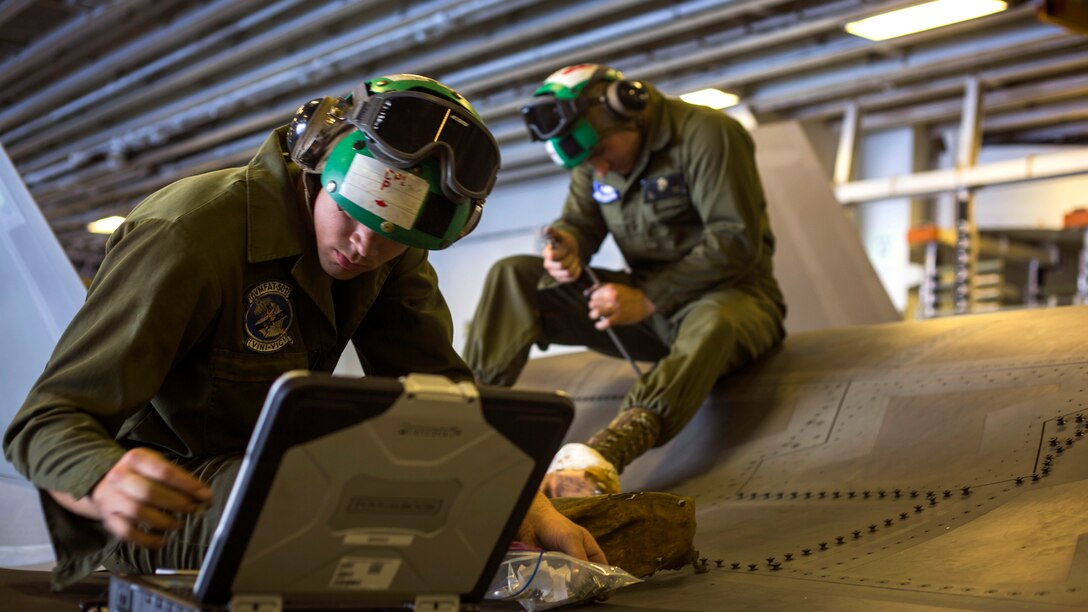 Cpl. Kendal Parish and Sgt. Arben Kupa, both Airframe Mechanics from Marine Fighter Attack Training Squadron 501, reinstall a panel of an F-35B Lightning II Joint Strike Fighter after maintenance aboard the USS Wasp, May 24, 2015. The Maintainers from VMFAT-501  are aboard the Wasp to support maintenance of the F-35B during the operational testing period.