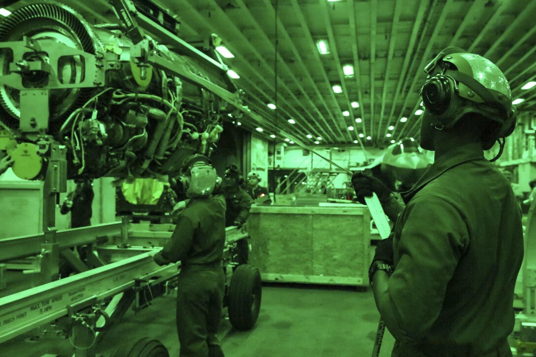 Marines with Test and Evaluation Squadron 22 move a power module for the F-35B Lightning II in the hanger bay of the USS Wasp, at sea May 23 during an evolution part of Operational Testing 1. The F-35B is the future of Marine Corps aviation and will be replacing three legacy platforms; the AV-8B Harrier, the F/A Hornet, and the EA-6B Prowler.