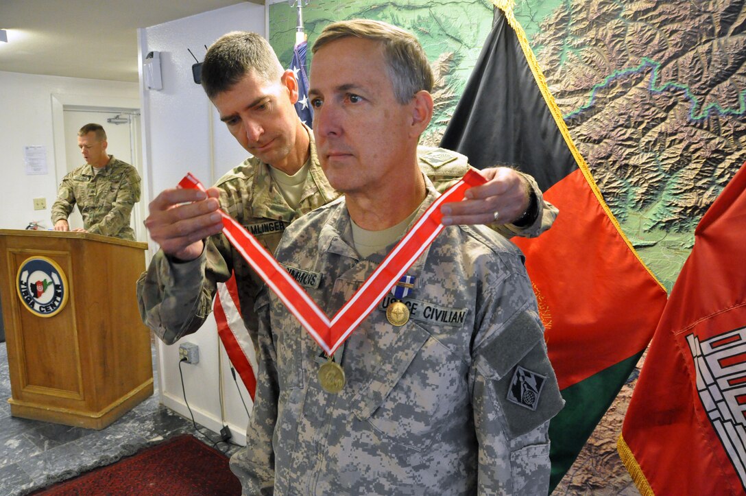 Gordon Simmons (right), chief of engineering, USACE Savannah District, currently deployed to Afghanistan, receives the Bronze Order of the de Fleury Medal from Col. Pete Helmlinger, commander, USACE Transatlantic- Afghanistan District,  Monday at Bagram Airfield, Afghanistan. 