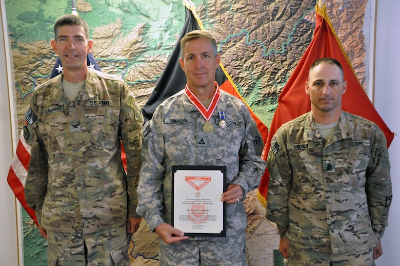 Gordon Simmons (center), chief of engineering, USACE Savannah District, currently deployed to Afghanistan, poses with Col. Pete Helmlinger (left), commander, USACE Transatlantic- Afghanistan District and Command Sgt. Maj. Christopher Lococo, USACE-TAA, Monday at Bagram Airfield, Afghanistan, after being presented with the Bronze Order of the de Fleury Medal.