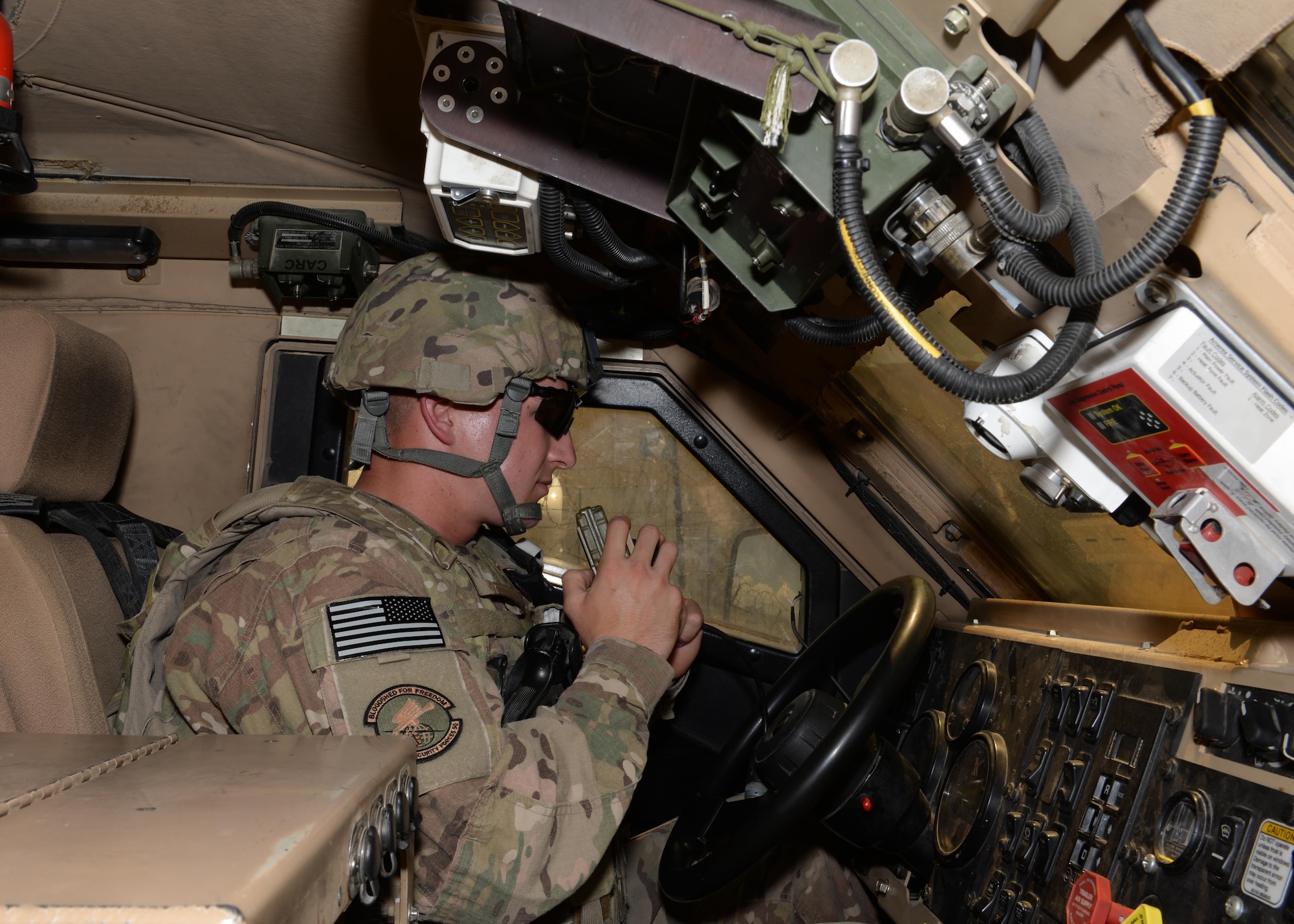 U.S. Air Force Senior Airman Tyler Simpson, 455th Expeditionary Security Forces Squadron combat patrolman, sits in a Mine-Resistant Ambush Protected vehicle awaiting instruction May, 29, 2015, at Bagram Air Field, Afghanistan.  Simpson, who’s duties of protecting the base include, flight line entry control checker, flight line security patrolman and first responder to all incidents on the base, is part of the last few ‘thousand’ Airmen here that have a hand in delivering technology and courage to protect the base and our Afghans partners. (U.S. Air Force photo by Senior Airman Cierra Presentado/Released)