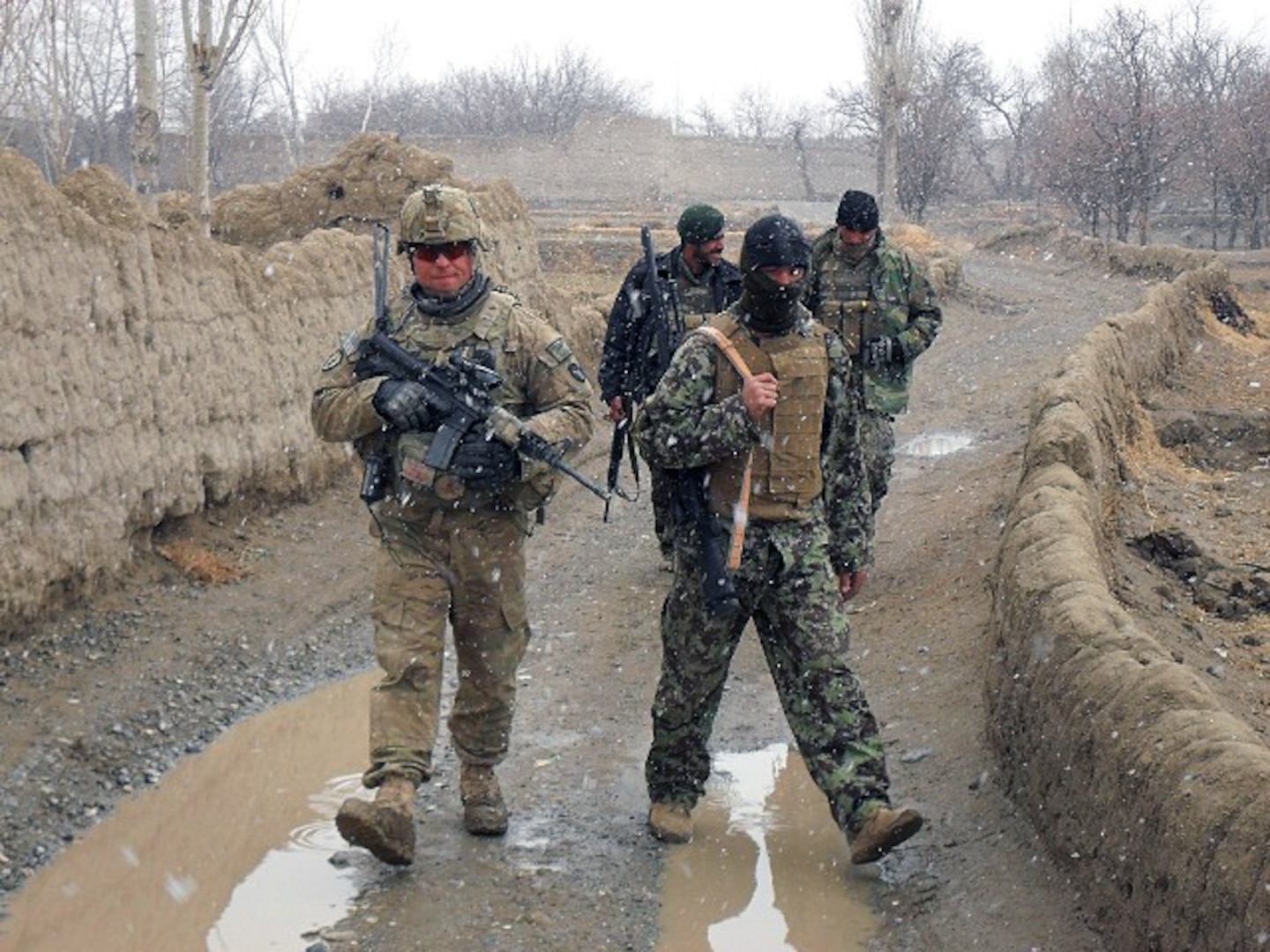 Army Staff Sgt. Clint Koerperich, an Iowa Guardmember and squad leader for 2nd Platoon, Company C., 1st Battalion, 168th Infantry Regiment, patrols with Afghan National Army soldiers to investigate possible insurgent cache locations in the Zormat District on Feb. 5, 2011. The ANA and 2nd Platoon responded to a tip provided to the ANA by the Guardians of Peace program, which is designed to allow villagers to give information anonymously to Afghan National Security Forces and coalition forces.