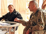 Army Gen. David H. Petraeus, left, International Security Assistance Force commander, and Col. Ben Correll, right, 2nd Brigade Combat Team, 34th Infantry Division commander, talk together in a pavilion outside the governor's compound in Mehtar Lam Feb. 7, 2011. The general met with Red Bulls and local Afghan leaders during his visit to the Laghman Province.