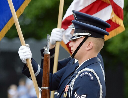 A U.S. Air Force Honor Guardsman presents the colors during the opening ceremonies of the inaugural performance of the 2015 U.S. Air Force Band Summer Concert Series at the Air Force Memorial in Arlington, Va., May 29, 2015.  (U.S. Air Force photo/Andy Morataya)