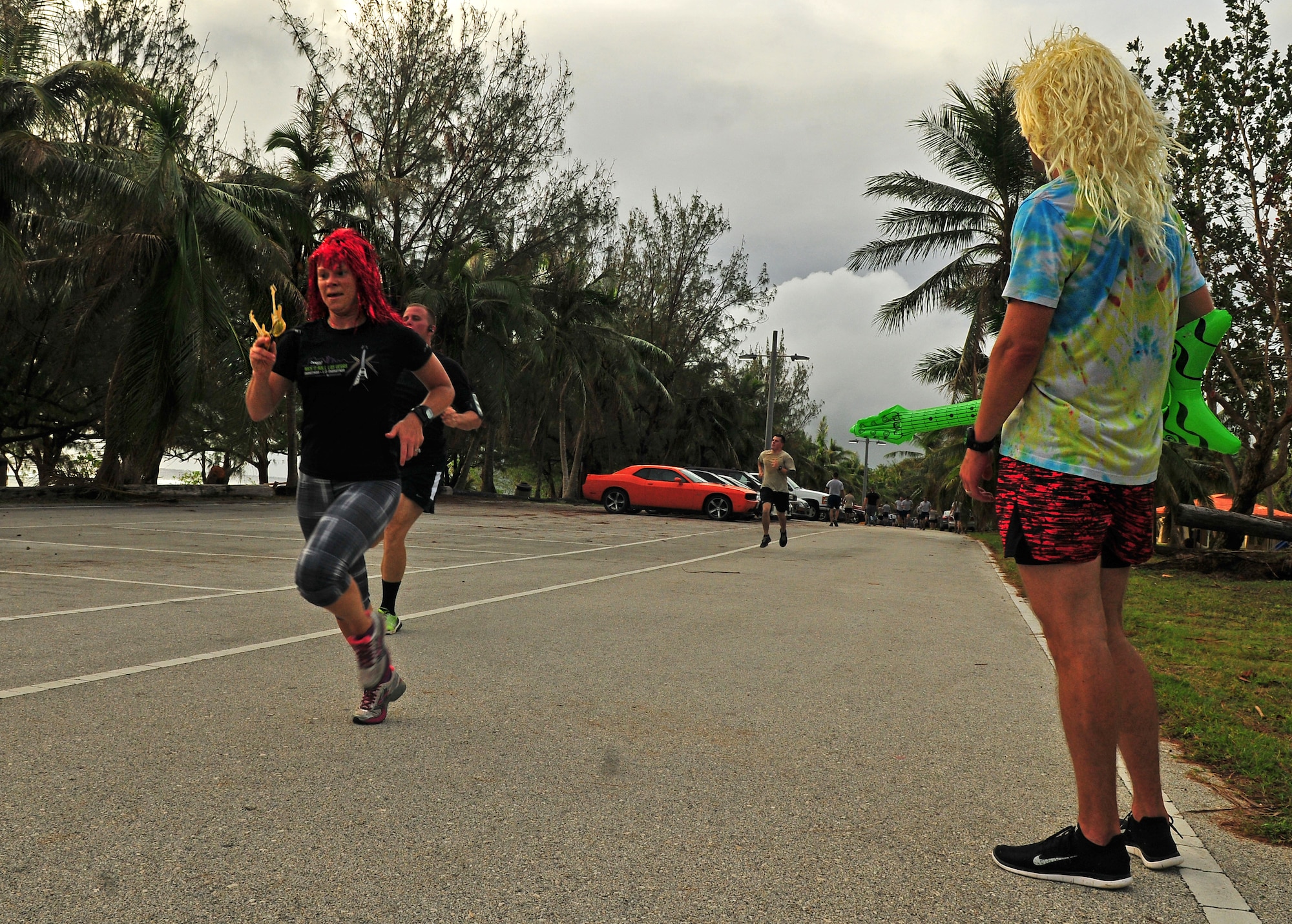 Runners approach the finish line of the Rock ‘n’ Roll 5K, June 3, 2015, at Tarague Beach on Andersen Air force Base, Guam. Some athletes donned rock music-themed costumes for the event. (U.S. Air Force photo by Senior Airman Alexander W. Riedel/Released)