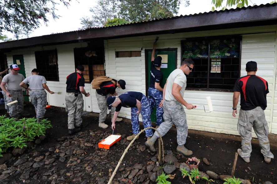 Military members from the U.S., New Zealand and Australia paint Iufi-Iufa Primary School during Pacific Angel at Asaro District, Papau New Guinea, May 30, 2015. Pacific Angel is an annual joint humanitarian assistance mission that is designed to bring humanitarian civic assistance and combined civil-military operations in the Pacific region. (U.S. Air Force photo by Staff Sgt. Marcus Morris/Released)