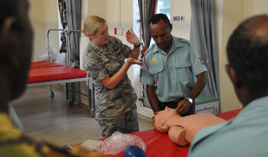 U.S. Air Force Capt. Alexis Beauvais, the flight surgeon subject matter expert exchange leader for Pacific Angel 15-4, demonstrates airway clearing techniques alongside a medic from the Papua New Guinea Defence Force to other PNGDF nurses, flight surgeons and technicians, May 24, 2015, Port Moresby, Papua New Guinea. PACANGEL is a U.S. Pacific Command multilateral humanitarian assistance civil military operation, which aims to improve military-to-military partnerships in the Pacific through medical health outreach, civic engineering projects and subject matter exchanges among partner forces. (U.S. Air Force photo by 1st. Lt. Michael Harrington/Released)