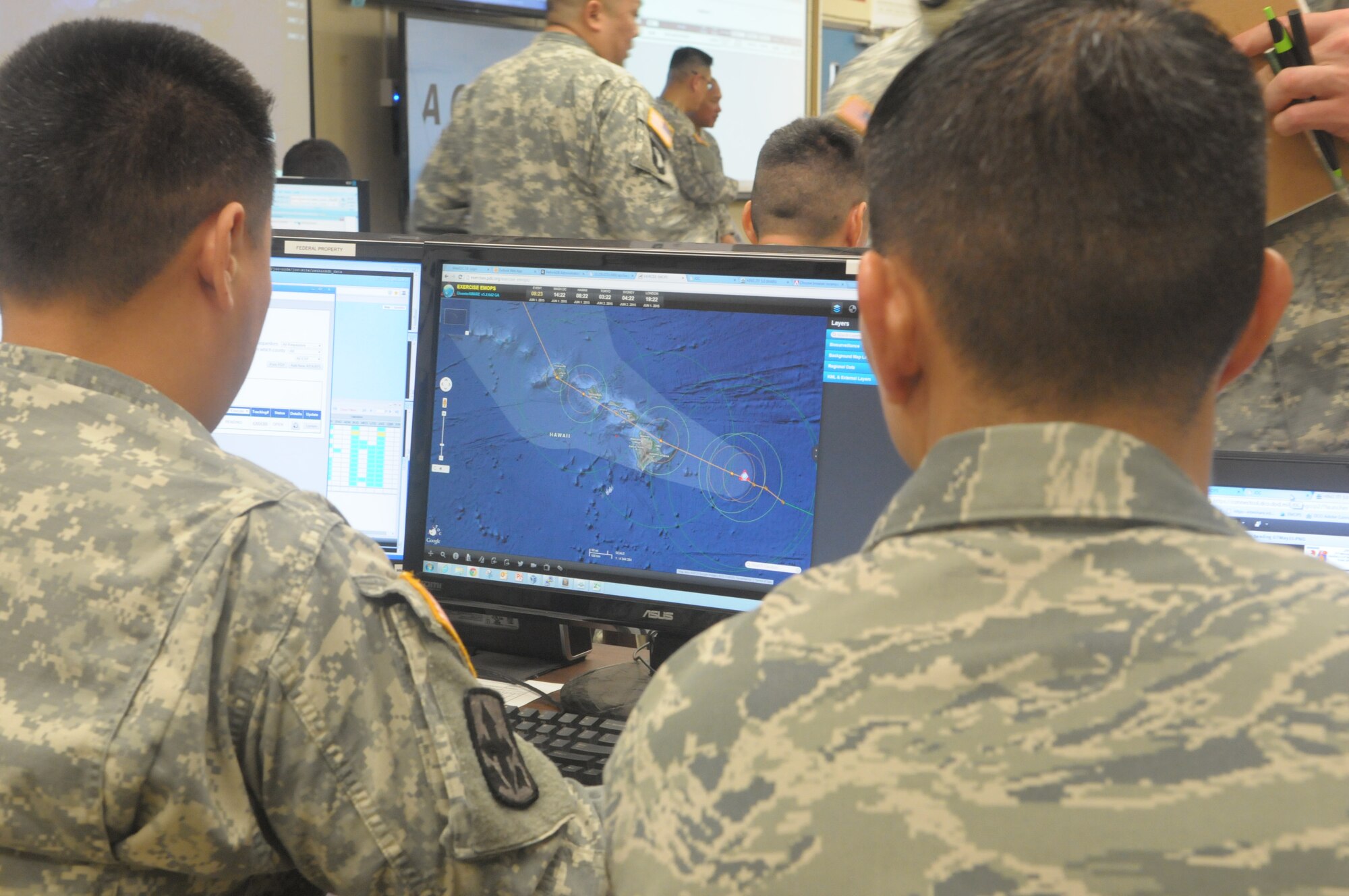 Hawaii National Guardsmen track a simulated hurricane during the exercise Vigilant Guard/Makani Pahili 2015 at the Joint Task Force 5-0 command center in the Hawaii National Guard (HING) Diamond Head Headquarters, Hawaii on June 1, 2015. The exercise provides an opportunity for the State of Hawaii and National Guard to improve collaborative efforts in regards to emergency preparation, coordination, response and recovery with federal, regional, local, civilian and military partners during domestic emergencies and catastrophic events. (U.S. Air National Guard photo by Airman 1st Class Robert Cabuco)