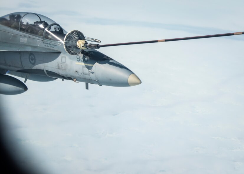 A Royal Canadian Air Force CF-18 Hornet receives fuel during aerial refueling from a 22nd Air Refueling Wing KC-135 Stratotanker from McConnell Air Force Base, Kan., operated by a 92nd Air Refueling Wing crew from Fairchild AFB, Wash., during exercise AMALGAM DART 15-2 May 29, 2015, over the Arctic Ocean. A Tanker Task Force assembled from the 92nd and 22nd ARWs joined approximately 300 military personnel and 15 aircraft in exercise AMALGAM DART 15-2 May 26 through June 1. (U.S. Air Force photo/Staff Sgt. Benjamin W. Stratton)