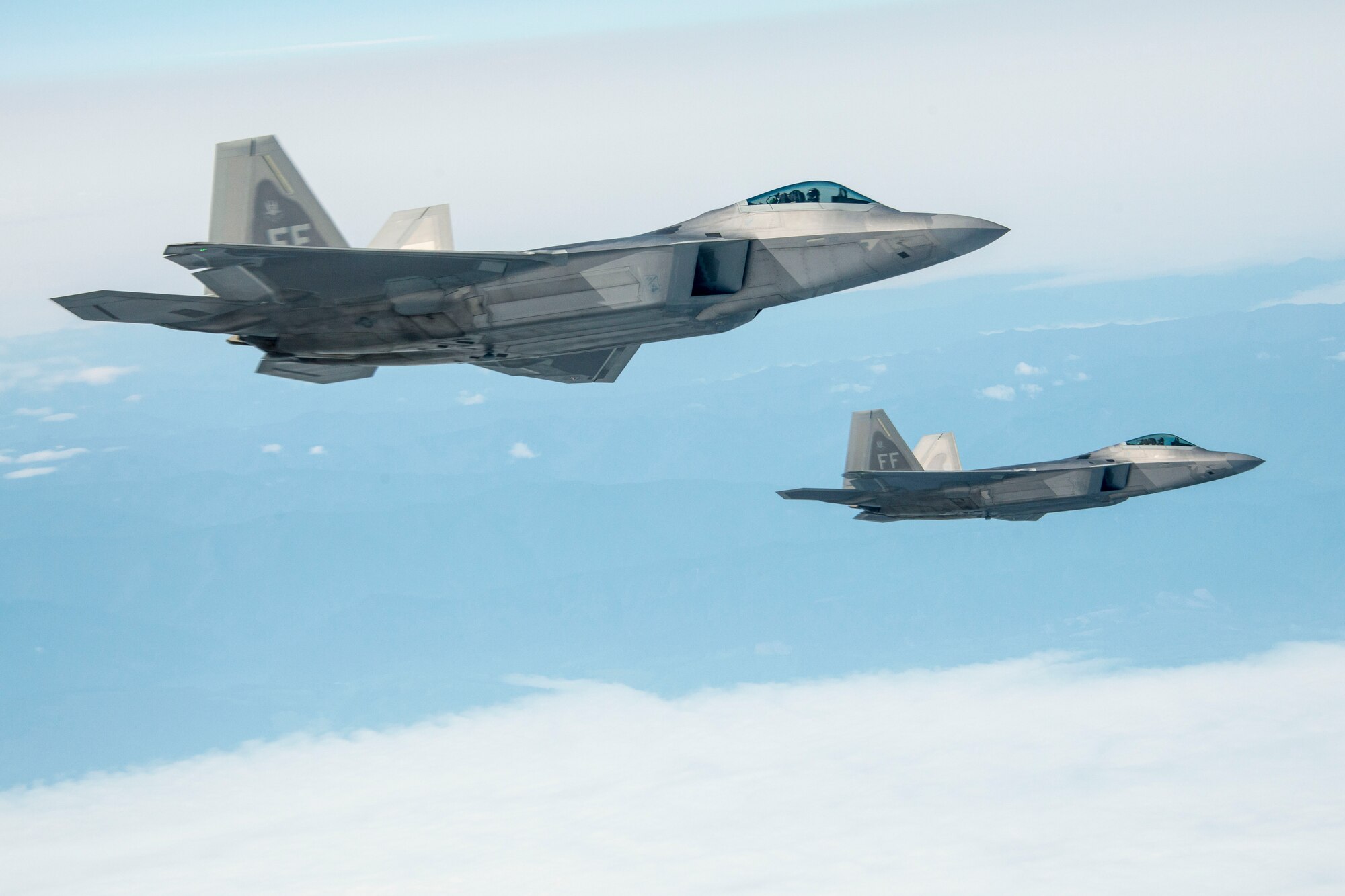Two F-22 Raptors from the 1st Fighter Wing at Joint Base Langley-Eustis escort a 92nd Air Refueling Wing KC-135 Stratotanker from Fairchild AFB, Wash., on their way to exercise AMALGAM DART 15-2 May 27, 2015, over British Columbia, Canada. The F-22 Raptor is the Air Force's newest fighter aircraft. Its combination of stealth, supercruise, maneuverability, and integrated avionics, coupled with improved supportability, represents an exponential leap in warfighting capabilities. The Raptor performs both air-to-air and air-to-ground missions allowing full realization of operational concepts vital to the 21st century Air Force. (U.S. Air Force photo/Staff Sgt. Benjamin W. Stratton)
