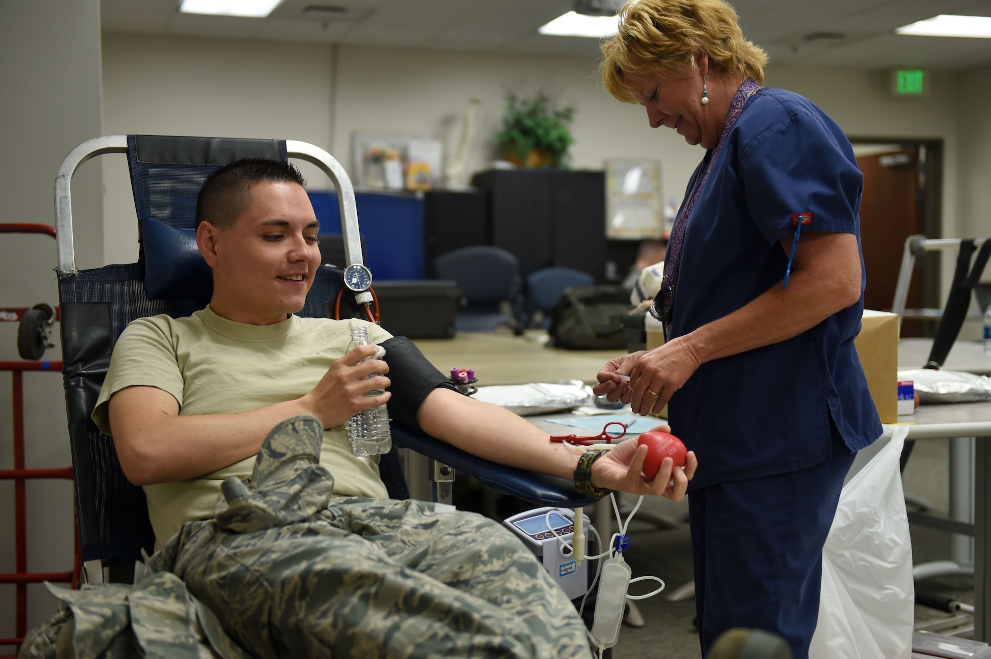Staff Sgt. Isaac R. Salazar, 460th Space Wing plans manager, gets his blood drawn by Joyce Kissle, Bonfils Blood Bank phlebotomist, during the blood drive June 2, 2015, at the Health and Wellness Center on Buckley Air Force Base, Colo. The blood drive was to support hospitals in the local area. (U.S. Air Force photo by Airman 1st Class Emily E. Amyotte/Released)