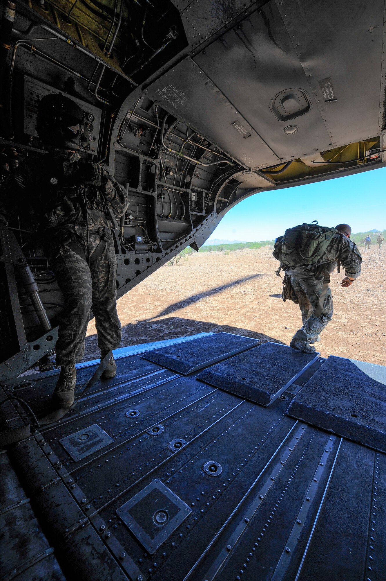 U.S. Army Staff Sgt. Westly Vincent, Task Force Tatanka, CH-47D Chinook flight engineer, monitors the landing area as U.S. Air Force Survival, Evasion, Resistance, and Escape Airmen from the 22nd Training Squadron, Fairchild Air Force Base, Wash., exits a CH-47D for search and rescue training mission during Angel Thunder 2015 at Ruby Fuzzy MOA, Ariz., June 2, 2015. The objective of the exercise is to train personnel recovery forces to prepare, plan, execute and adapt for a rescue mission. (U.S. Air Force photo by Staff Sgt. Angela Ruiz/Released)