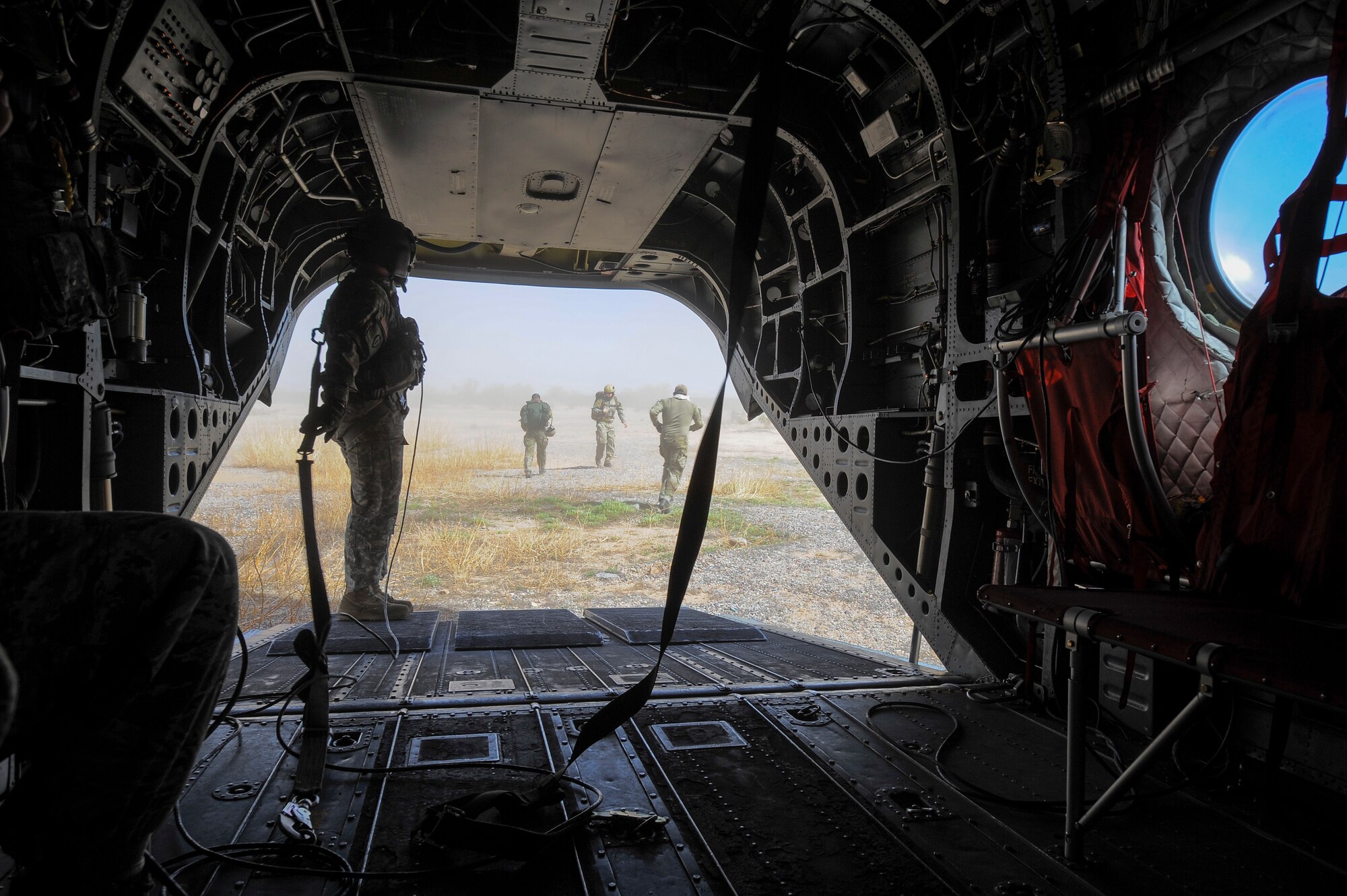 U.S. Army Staff Sgt. Westly Vincent, Task Force Tatanka, CH-47D Chinook flight engineer, monitors the landing area of a CH-47D as U.S. Air Force Survival, Evasion, Resistance, and Escape Airmen, 22nd Training Squadron from Fairchild Air Force Base, Wash., depart for a search and rescue training mission during Angel Thunder 2015 at Ruby Fuzzy MOA, Ariz., June 2, 2015. The objective of the exercise is to train personnel recovery forces to prepare, plan, execute and adapt for a rescue mission. (U.S. Air Force photo by Staff Sgt. Angela Ruiz/Released)