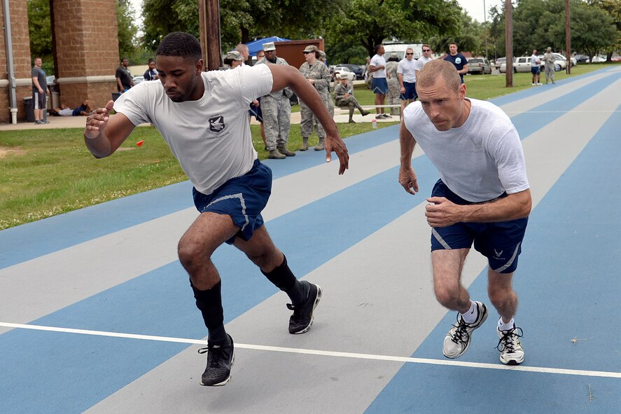 Airmen compete in a 1.5 Mile Relay during Sports Day at Barksdale Air Force Base, Louisiana, May 29, 2015. Sports Day is an annual event giving Airmen an opportunity to participate in team sports and help increase morale and fitness awareness. (U.S. Air Force photo/Tech. Sgt. Marie Brown)