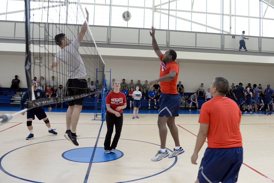 Airmen with the 2nd Civil Engineer Squadron and 2nd Force Support Squadron compete in a Sports Day volleyball game at Barksdale Air Force Base, Louisiana, May 29, 2015. Sports Day is comprised of various competitive athletic events to promote physical fitness. (U.S. Air Force photo/Tech. Sgt. Marie Brown)
