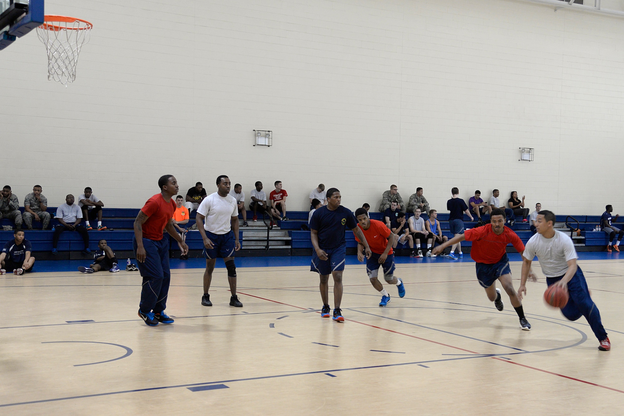Airmen with the 2nd Logistics Readiness Squadron and 2nd Force Support Squadron compete in a Sports Day 3-on-3 basketball game at Barksdale Air Force Base, Louisiana, May 29, 2015. Sports Day was designed to improve teamwork and help increase the awareness of fitness, sports programs and boost morale. (U.S. Air Force photo/Tech. Sgt. Marie Brown)