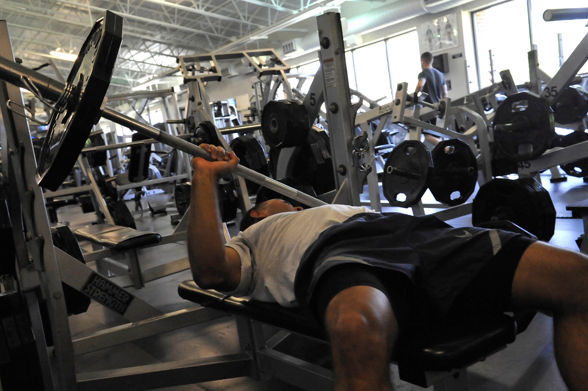 U.S. Air Force Senior Airman Marcus Hairston, 633rd Civil Engineering Squadron technician, demonstrates an unsafe bench press at the Shellbank Fitness Center on Langley Air Force Base, Va., June 1, 2015. Lifting too much weight and not using the weight clasps can cause injury to Airmen. (U.S. Air Force photo by Senior Airman Breonna Veal/Released)
