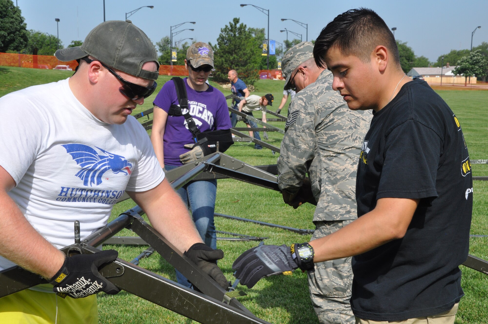 Senior Airman Aaron Ewy and Airman 1st Class Luis Matamoros, 931st Civil Engineering Squadron emergency managers, set up tents for the Special Olympics of Kansas, June 3.  Ten 931st CES Airmen set up general purpose tents for the organization's 45th Annual Summer Games at the Wichita State University Campus. Reservists from the 931st CES have provided tents and set up for the event for the past fifteen years.   (U.S. Air Force photo by Tech. Sgt. Abigail Klein)
