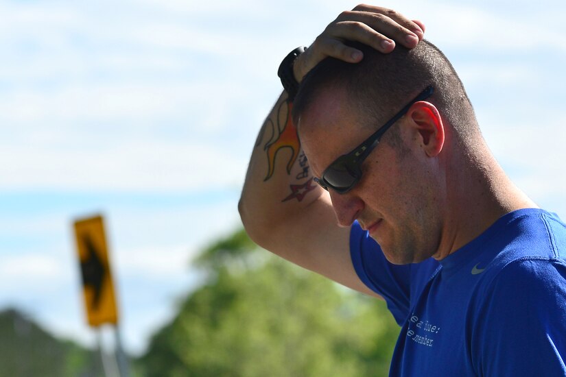 U.S. Army Staff Sgt. Jeffery Lewis, Charlie Company, 1st Battalion, 222nd Aviation Regiment platoon sergeant, takes a moment to reflect before running, at Fort Eustis, Va., May 12, 2015. Lewis is a marathon runner with a goal to run a marathon in each state in honor of fallen Service members and their families. (U.S. Air Force photo by Staff Sgt. Natasha Stannard/Released) 