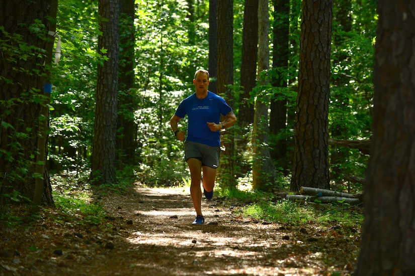 U.S. Army Staff Sgt. Jeffery Lewis, Charlie Company, 1st Battalion, 222nd Aviation Regiment platoon sergeant, runs through the nature trail at Fort Eustis, Va., May 12, 2015. Lewis is currently training for his 26th marathon, and is more than half way to his goal of running a marathon in each state. (U.S. Air Force photo by Staff Sgt. Natasha Stannard/Released) 